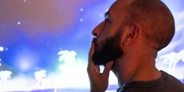 Man looking at an artwork at the Media Under Dystopia exhibition